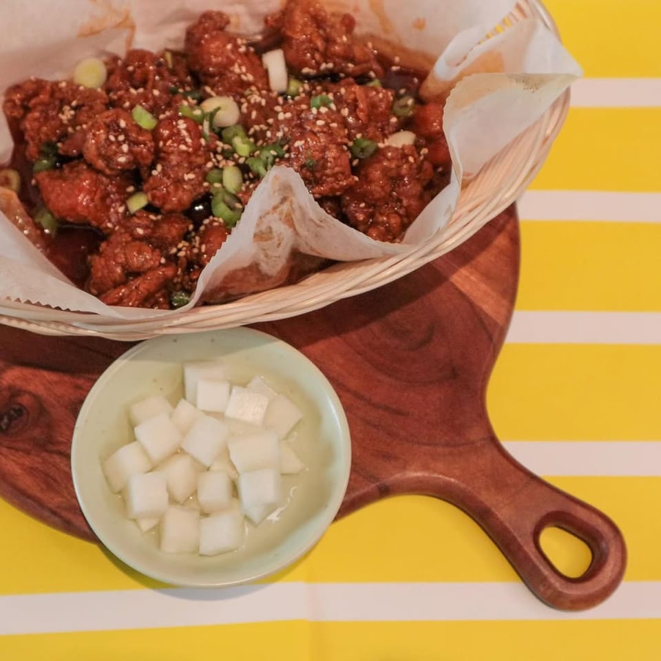 J's Korean Food's fried chicken with sesame seeds and scallions, served with pickled radish.