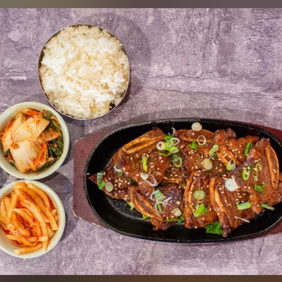 J's Korean Food Galbi, rice, and two side dishes of kimchi and pickled radish.